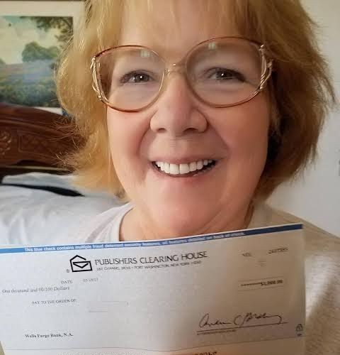 Enrollee holding her benefit check